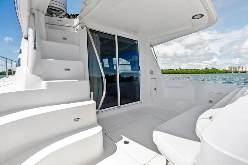 Megusta Yacht Photos Pics 2007 Sea Ray 44 Sedan Bridge yacht deck with stairs and seating, overlooking water.