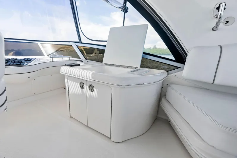 Megusta Yacht Photos Pics Luxurious interior of 2007 Sea Ray 44 Sedan Bridge yacht with white seating and cabinetry.