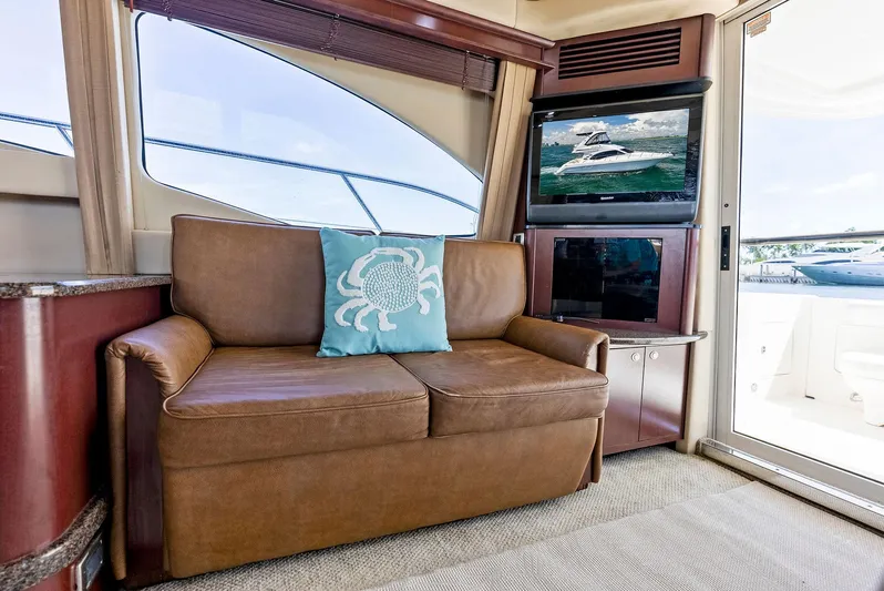 Megusta Yacht Photos Pics Luxurious interior of 2007 Sea Ray 44 Sedan Bridge yacht with leather sofa and TV.