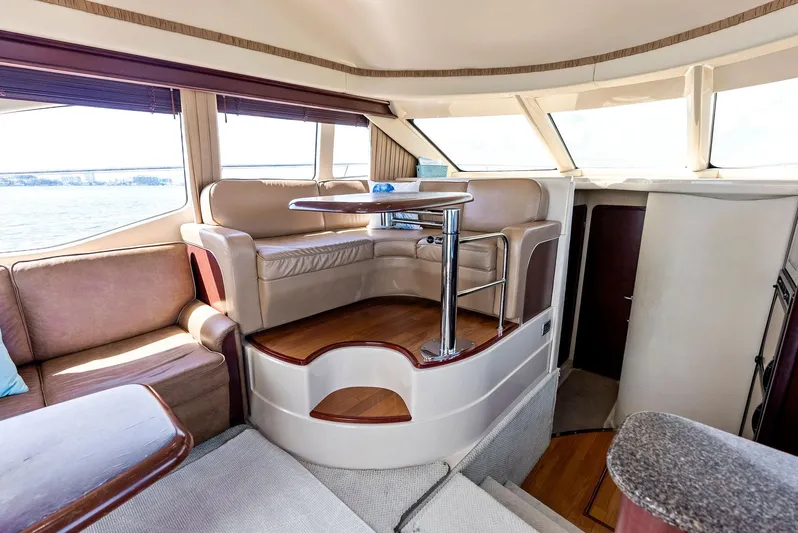 Megusta Yacht Photos Pics Luxurious interior of 2007 Sea Ray 44 Sedan Bridge yacht with elegant seating and panoramic windows.