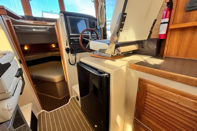  Yacht Photos Pics 2015 Ranger Tugs R-31 CB interior with helm, seating, and compact cabin amenities.