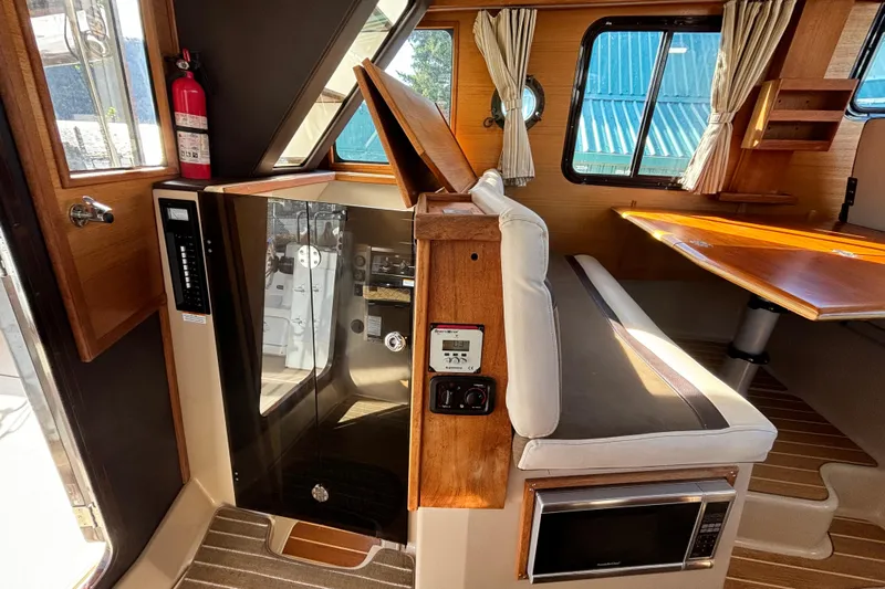  Yacht Photos Pics 2015 Ranger Tugs R-31 CB interior with seating, table, and microwave.