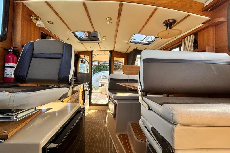  Yacht Photos Pics Interior of 2015 Ranger Tugs R-31 CB, featuring seating and wooden accents.