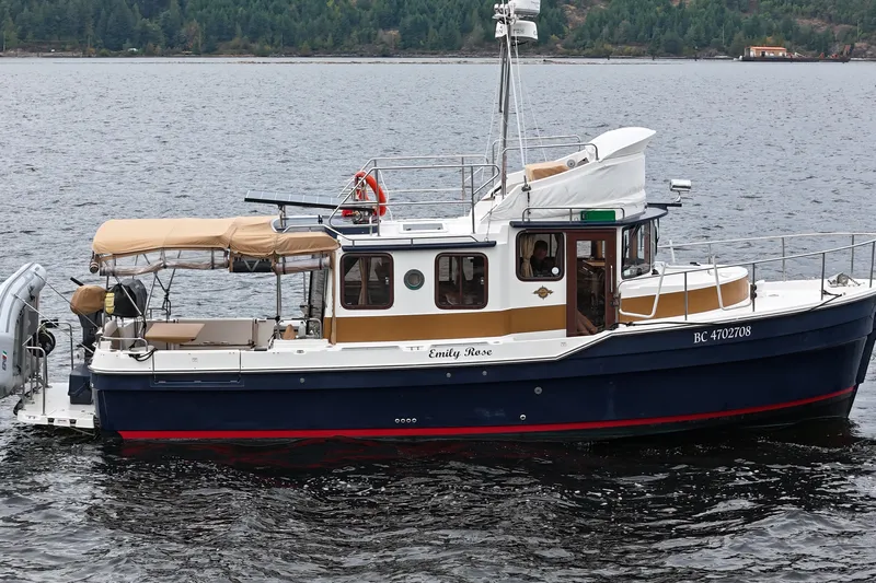  Yacht Photos Pics 2015 Ranger Tugs R-31 CB boat on water, featuring a classic design and spacious deck.