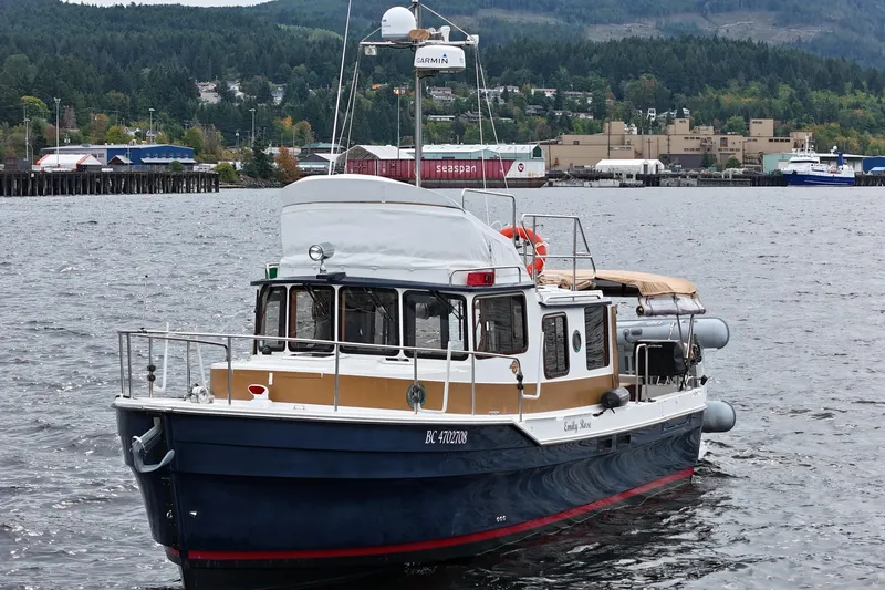  Yacht Photos Pics 2015 Ranger Tugs R-31 CB boat on water, scenic background, industrial area.