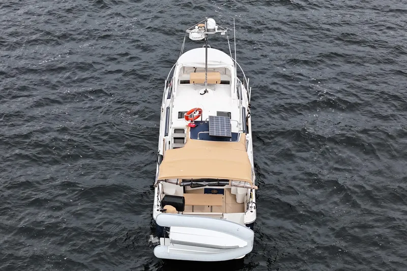  Yacht Photos Pics 2015 Ranger Tugs R-31 CB boat on water, aerial view, with solar panel and dinghy.