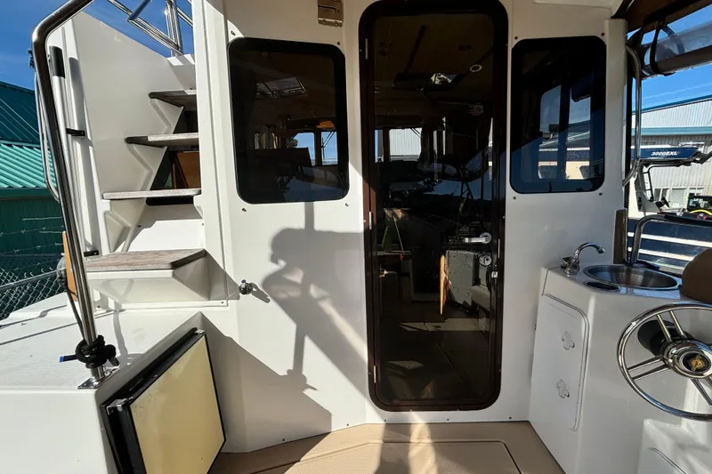 Yacht Photos Pics 2015 Ranger Tugs R-31 CB boat interior with stairs and kitchenette.