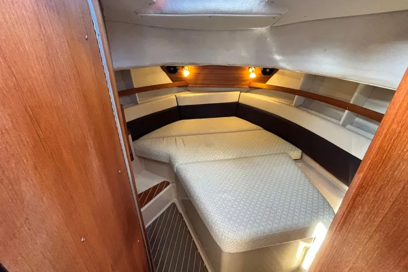  Yacht Photos Pics 2015 Ranger Tugs R-31 CB cabin interior with cozy bed and warm lighting.