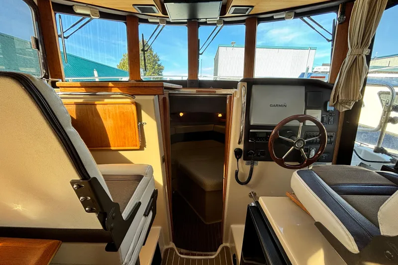  Yacht Photos Pics 2015 Ranger Tugs R-31 CB interior with helm, Garmin display, and seating.