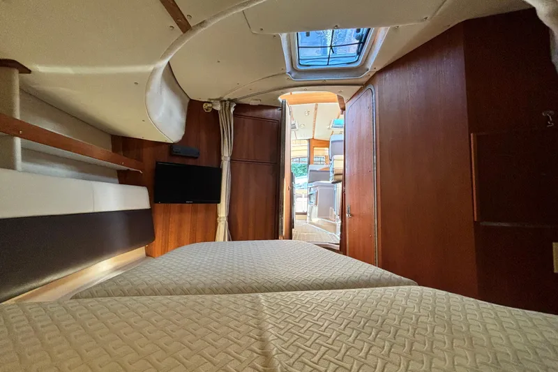  Yacht Photos Pics 2015 Ranger Tugs R-31 CB interior cabin with twin beds and a small TV.