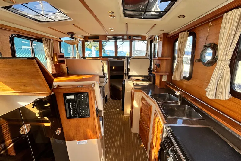  Yacht Photos Pics Interior of 2015 Ranger Tugs R-31 CB, featuring wood finishes and modern amenities.