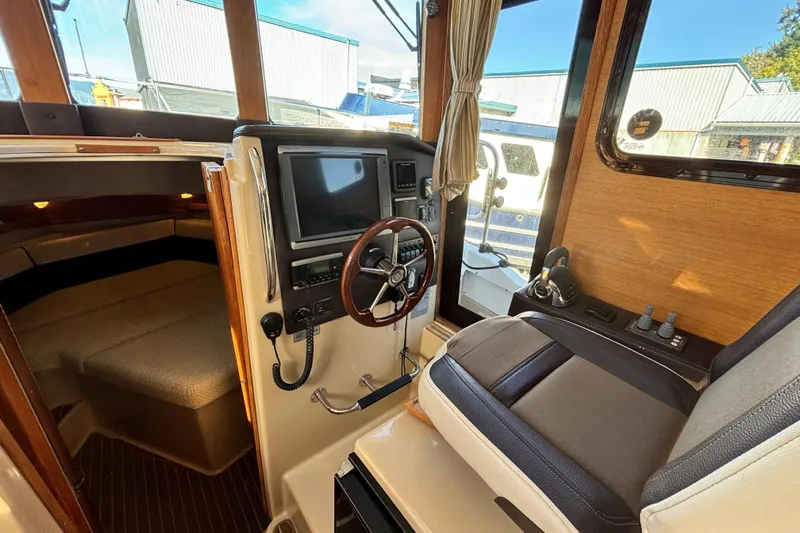  Yacht Photos Pics 2015 Ranger Tugs R-31 CB interior helm with steering wheel and navigation equipment.