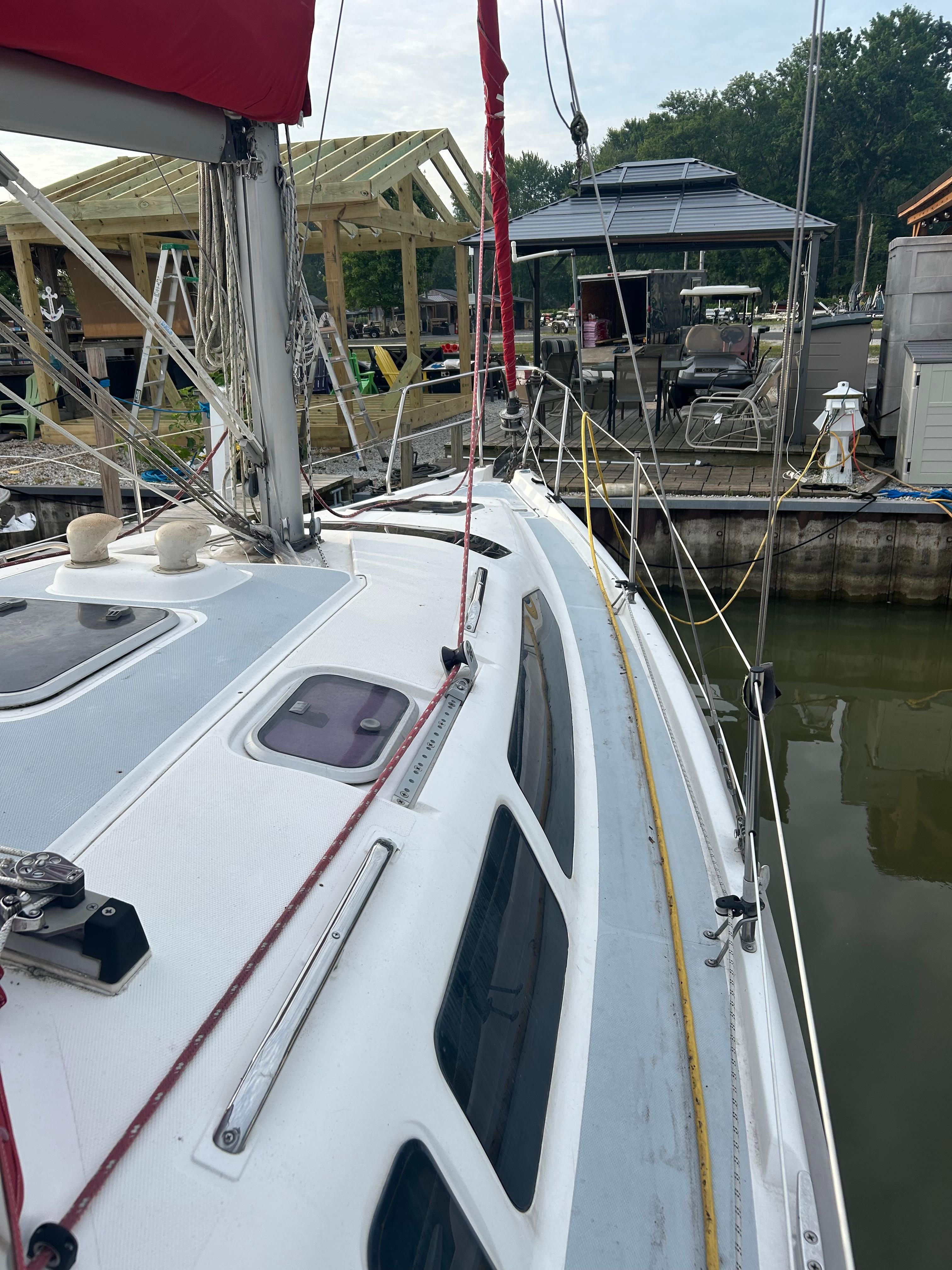 Sailboat docked at marina, Hunter 336 model, 1996, with visible rigging and deck details.