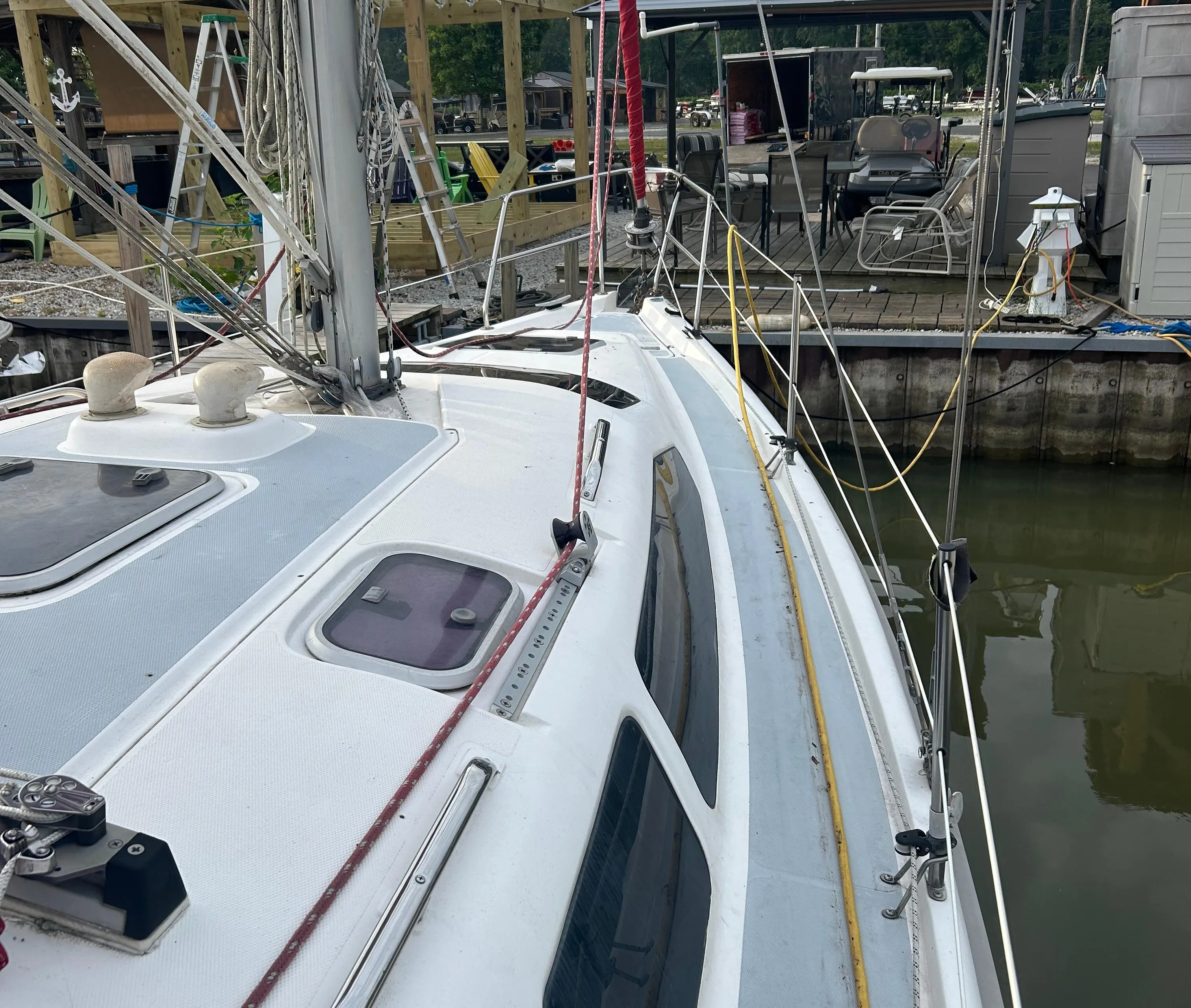 Sailboat docked at marina, Hunter 336 model, 1996, with visible rigging and deck details.