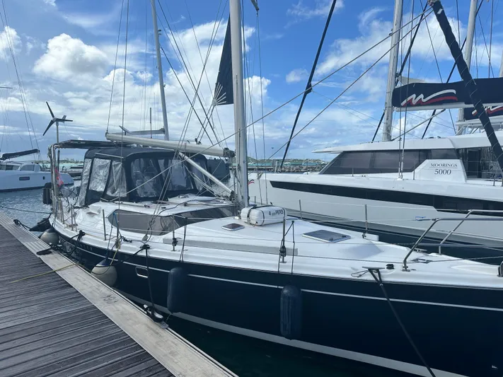 Talisa Yacht Photos Pics Sailboat docked at marina, Hunter 45cc model, 2006, under a partly cloudy sky.