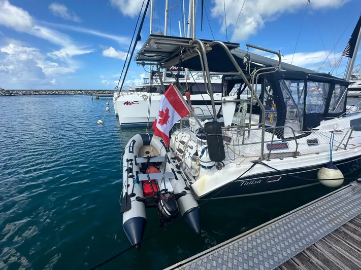 Talisa Yacht Photos Pics Sailboat docked with Canadian flag, Hunter 45cc, 2006 model, in a marina.