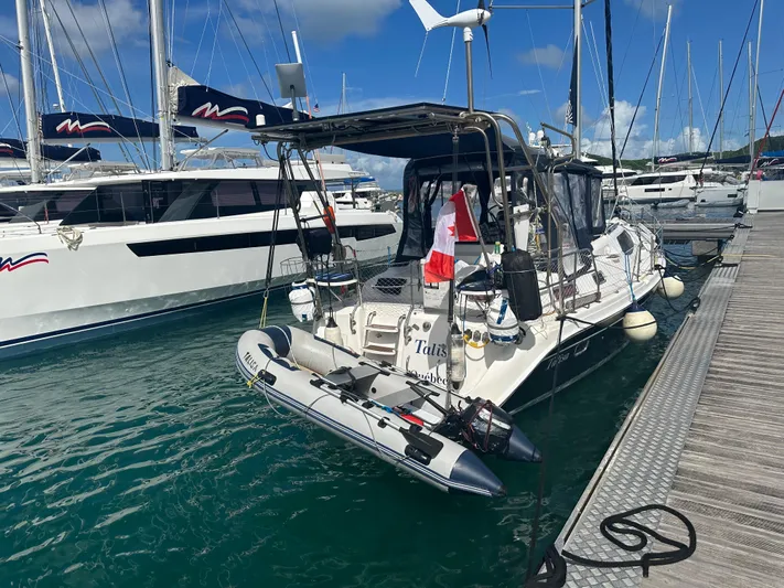 Talisa Yacht Photos Pics Sailboat Hunter 45cc 2006 docked with inflatable dinghy, marina background.