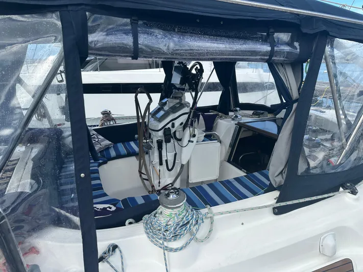 Talisa Yacht Photos Pics 2006 Hunter 45cc sailboat cockpit with striped seating and navigation equipment.