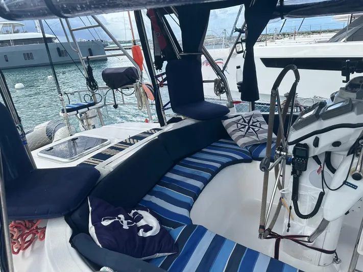 Talisa Yacht Photos Pics Cozy cockpit of 2006 Hunter 45cc sailboat with striped seating and nautical decor.