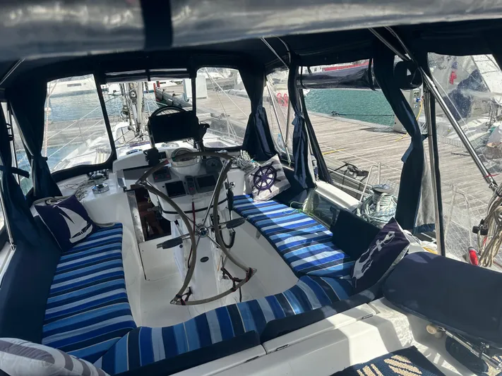 Talisa Yacht Photos Pics Interior of a 2006 Hunter 45cc sailboat with striped seating and nautical decor.