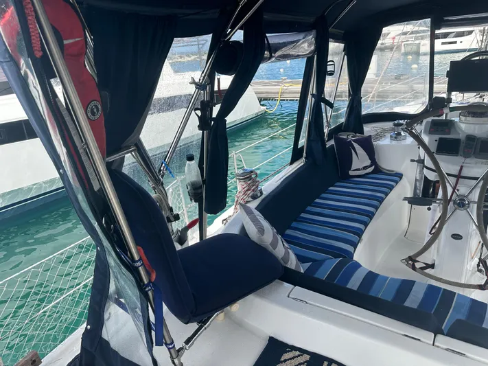 Talisa Yacht Photos Pics Interior of a 2006 Hunter 45cc sailboat with striped seating and nautical decor.