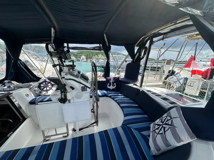 Talisa Yacht Photos Pics Interior of a 2006 Hunter 45cc sailboat with striped seating and nautical decor.