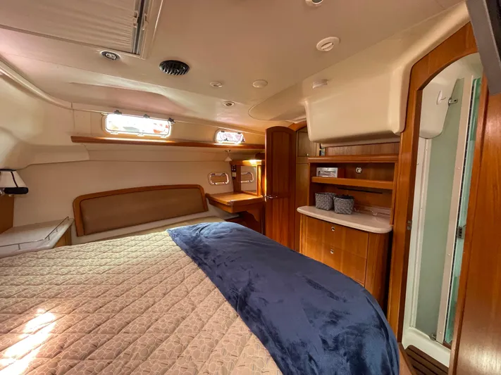 Talisa Yacht Photos Pics Luxurious cabin interior of a 2006 Hunter 45cc yacht with wood accents and cozy bedding.