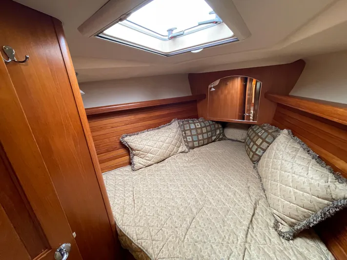 Talisa Yacht Photos Pics Cozy cabin interior of 2006 Hunter 45cc sailboat with skylight and plush bedding.