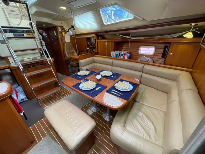Talisa Yacht Photos Pics Luxurious 2006 Hunter 45cc yacht interior with dining area, wooden finishes, and elegant seating.