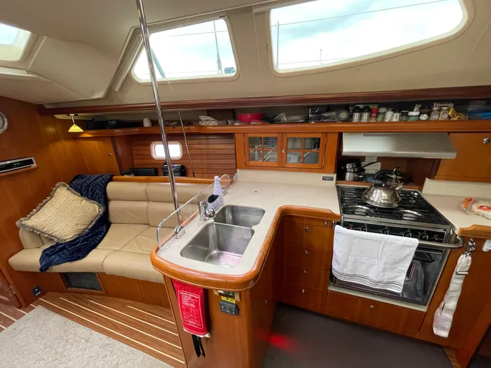 Talisa Yacht Photos Pics Interior of a 2006 Hunter 45cc yacht with kitchen and seating area.