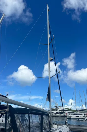 Talisa Yacht Photos Pics Sailboat mast of 2006 Hunter 45cc against a bright blue sky with clouds.