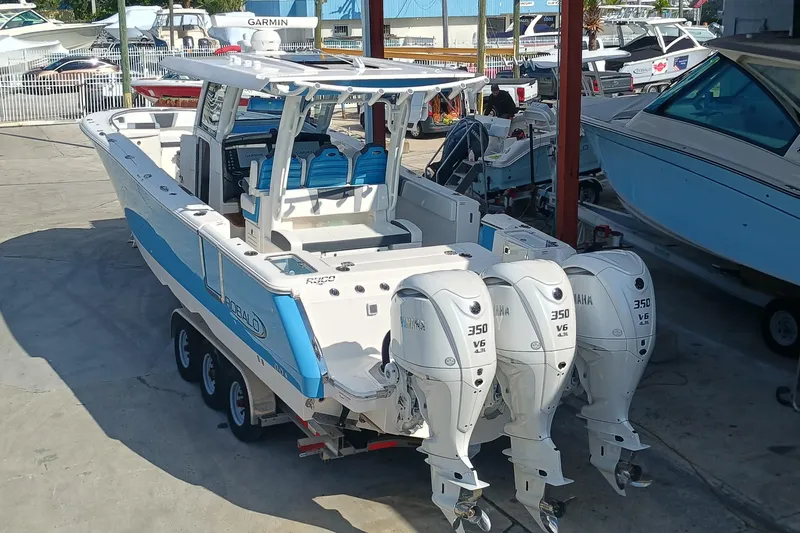 360-105 Yacht Photos Pics 2026 Robalo R360 Center Console boat with triple Yamaha 350 engines in a marina.