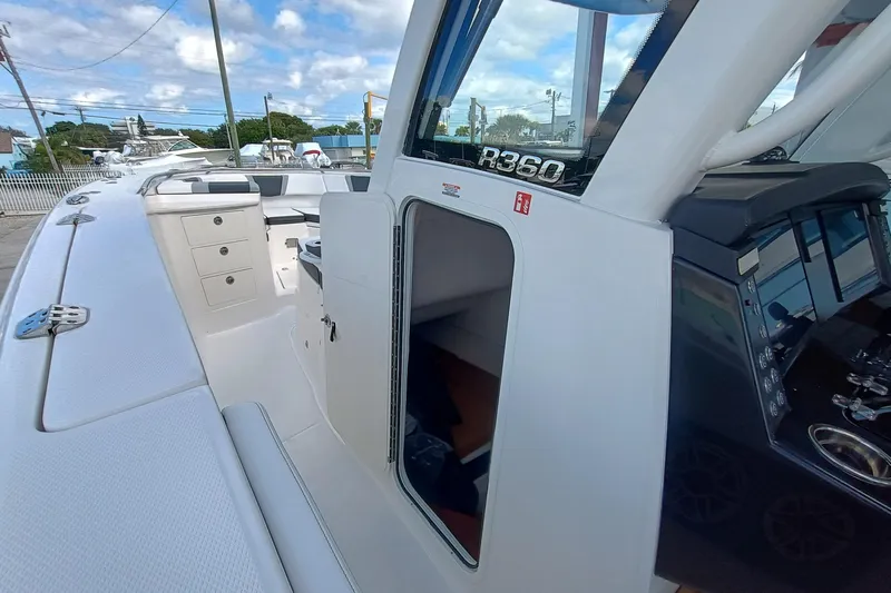 360-105 Yacht Photos Pics 2026 Robalo R360 Center Console boat interior with open cabin door and control panel.