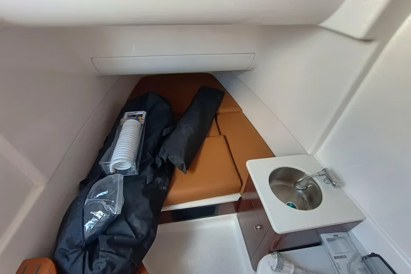 360-105 Yacht Photos Pics 2026 Robalo R360 Center Console cabin interior with sink and storage items.