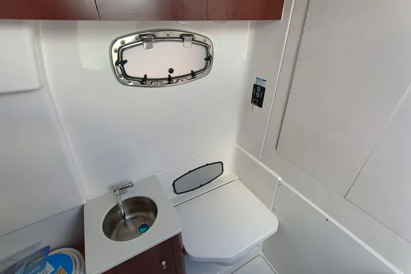 360-105 Yacht Photos Pics 2026 Robalo R360 Center Console boat bathroom with sink and toilet.