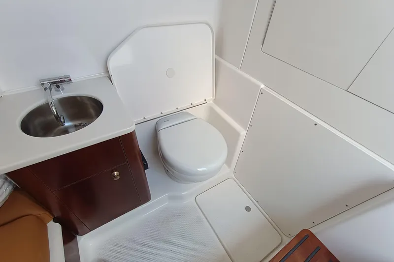 360-105 Yacht Photos Pics 2026 Robalo R360 Center Console boat bathroom with sink and toilet.