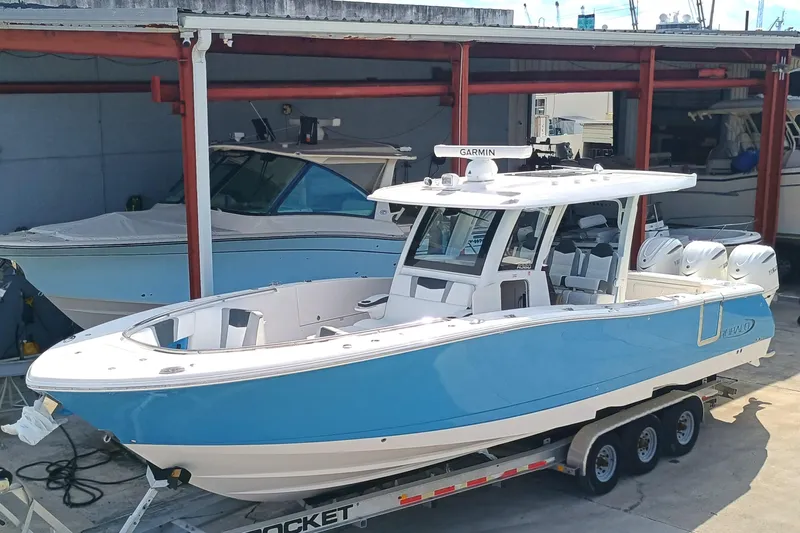 360-105 Yacht Photos Pics 2026 Robalo R360 Center Console boat on trailer in storage facility.
