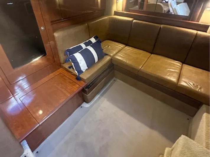  Yacht Photos Pics Luxurious interior of 2005 Sea Ray 390 Sundancer with leather seating and nautical decor.