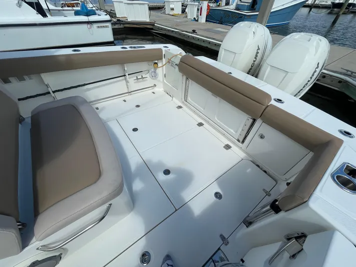  Yacht Photos Pics 2018 Boston Whaler 330 Outrage boat interior with seating and twin engines.