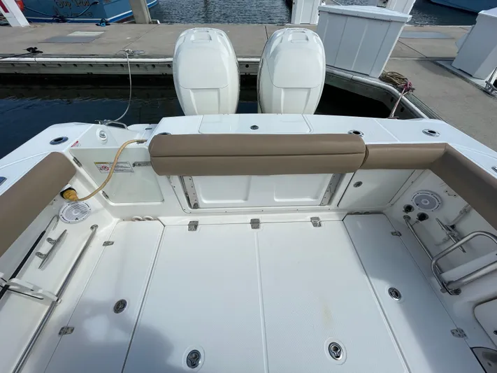  Yacht Photos Pics 2018 Boston Whaler 330 Outrage boat deck with twin engines at dock.