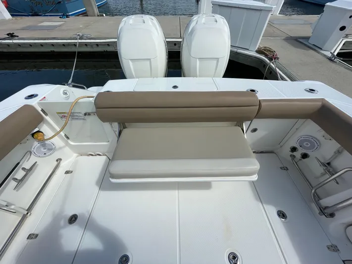  Yacht Photos Pics 2018 Boston Whaler 330 Outrage boat interior with seating and twin engines at dock.