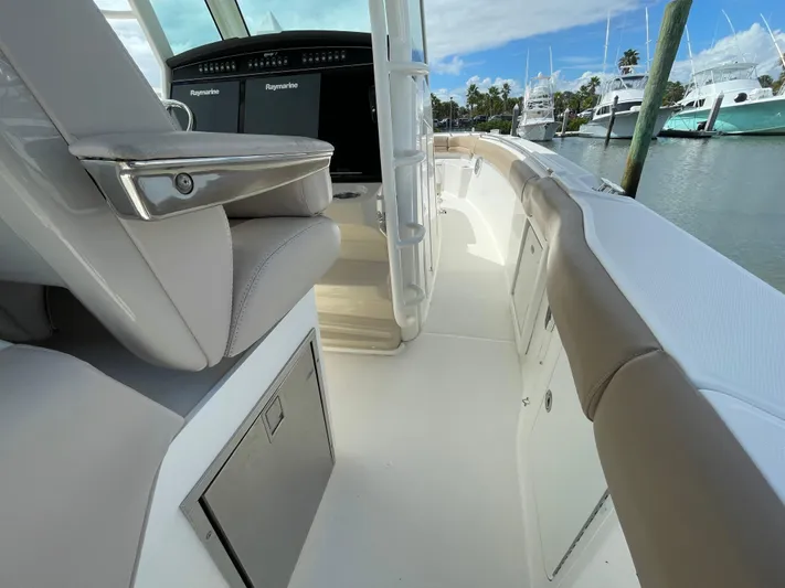  Yacht Photos Pics 2018 Boston Whaler 330 Outrage interior with seating and control panel, docked at marina.