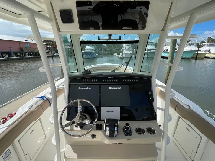  Yacht Photos Pics 2018 Boston Whaler 330 Outrage helm with dual Raymarine displays and steering wheel.