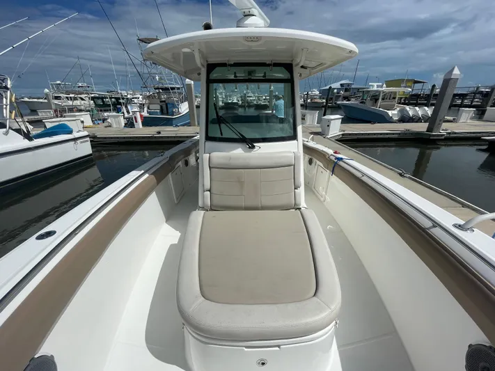  Yacht Photos Pics 2018 Boston Whaler 330 Outrage boat at marina, showcasing spacious deck and seating.