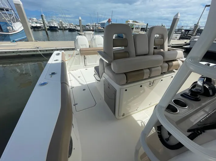  Yacht Photos Pics 2018 Boston Whaler 330 Outrage boat interior at marina, featuring seating and control panel.