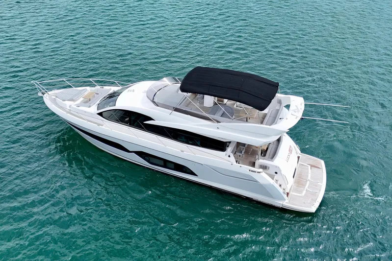  Yacht Photos Pics 2019 Sunseeker Manhattan 66 yacht cruising on clear blue waters.