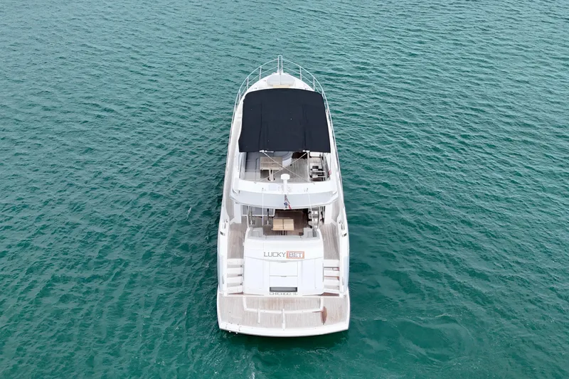  Yacht Photos Pics Aerial view of 2019 Sunseeker Manhattan 66 yacht on turquoise water.