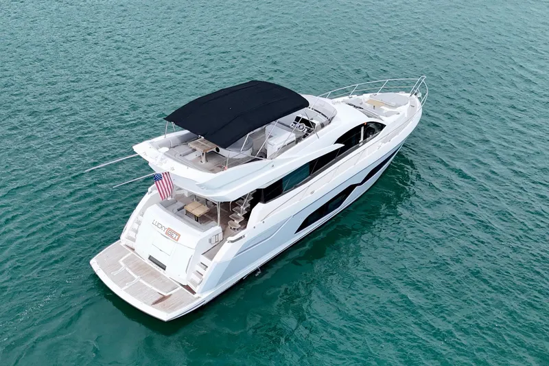  Yacht Photos Pics 2019 Sunseeker Manhattan 66 yacht cruising on open water, aerial view.