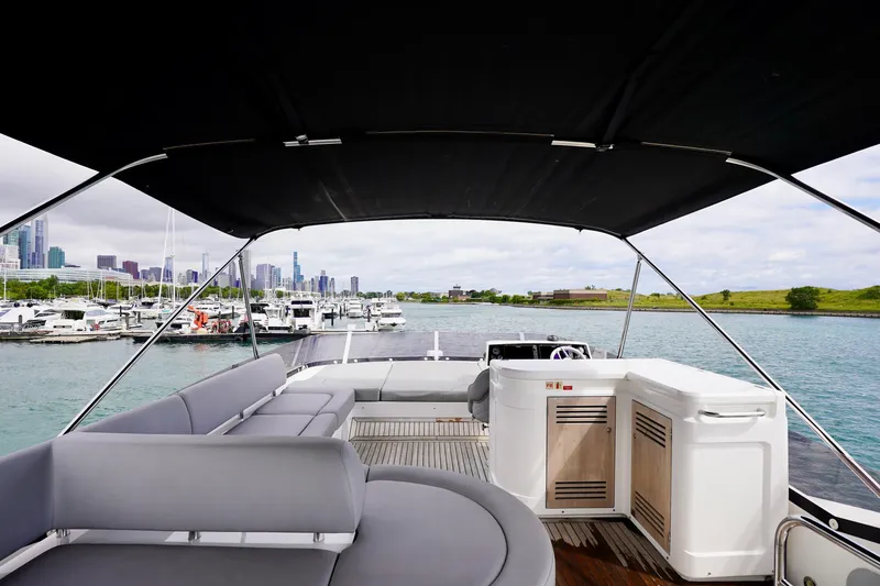  Yacht Photos Pics 2019 Sunseeker Manhattan 66 yacht interior with city skyline and marina view.
