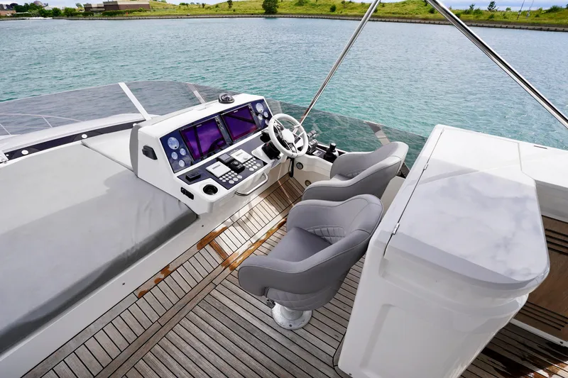  Yacht Photos Pics Flybridge helm of 2019 Sunseeker Manhattan 66 yacht with dual seats and navigation controls.